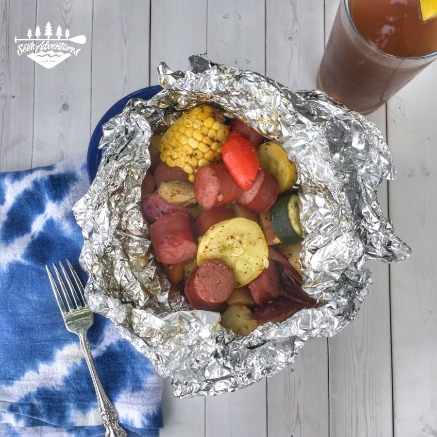 These grilled veggie and smoked sausage foil packs cook up quick and easy. These make for an easy camping meal or an quick weeknight dinner on the grill. #campingmeals #campingmenu #foilpacks #grillpacks #grilling campfire meals in packets campfire meals in foil foil packets foil packet recipes