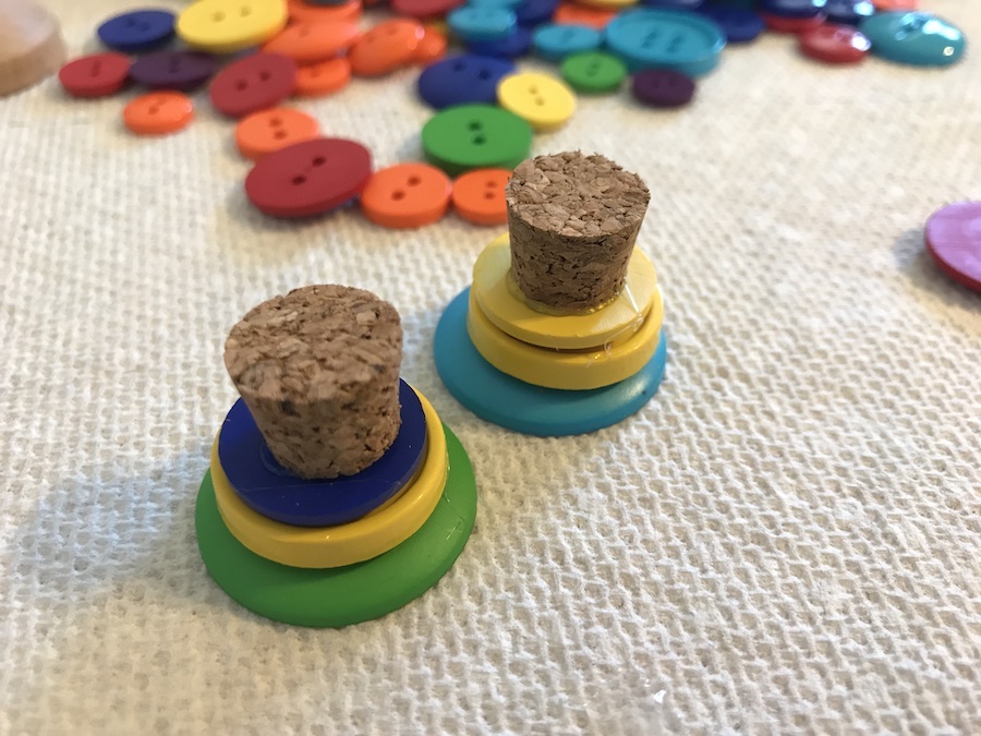 Glue buttons and corks to make the tops of the lanters. 