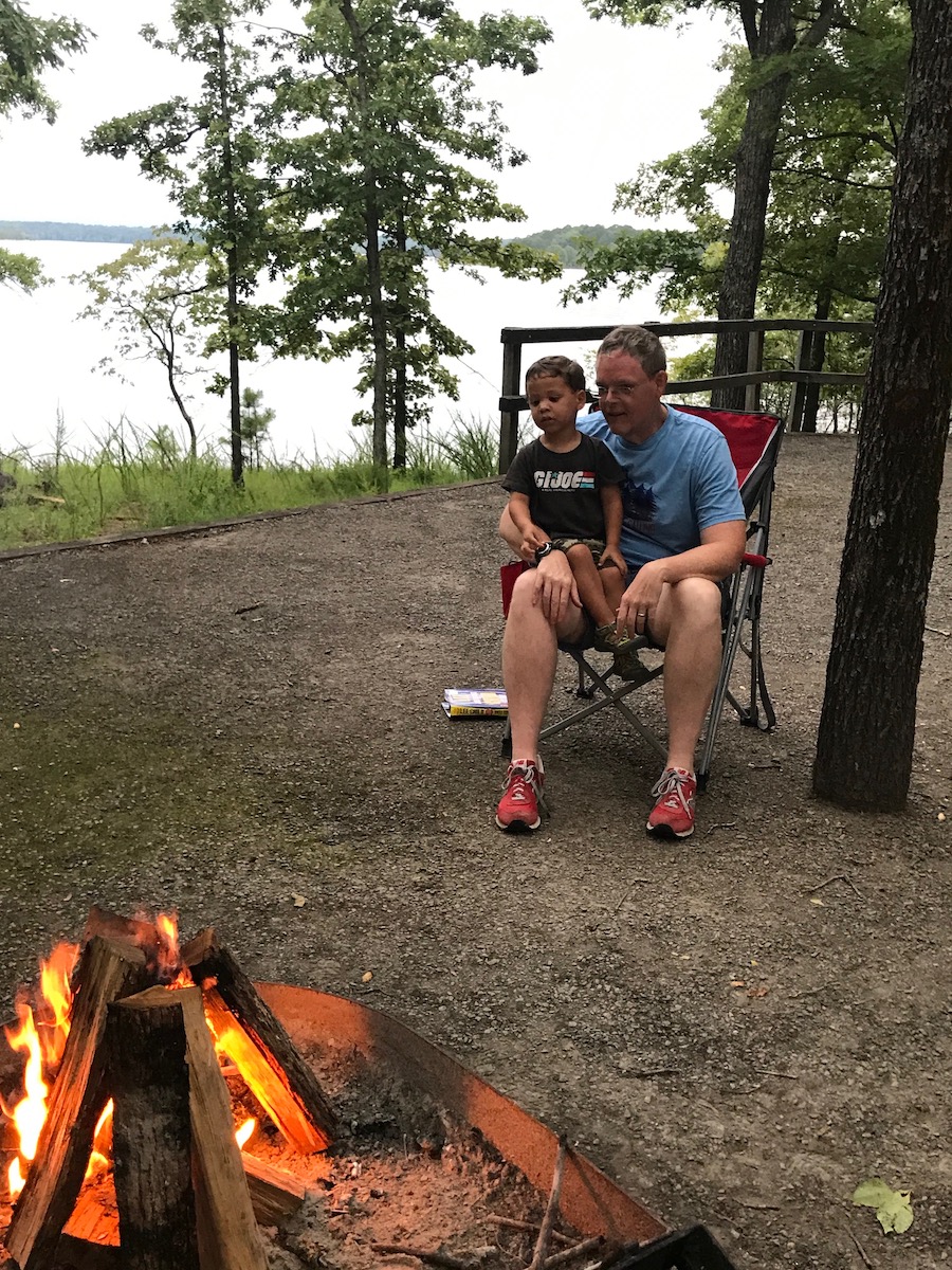 Father talks to his son about campfire safety tips. 